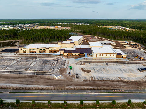 K-8 School NN is being built to accept students from the Rivertown and Shearwater communities in northern St. Johns County, Florida. It will open in Fall of 2024. These are aerial shots of the school under construction in April 2024.