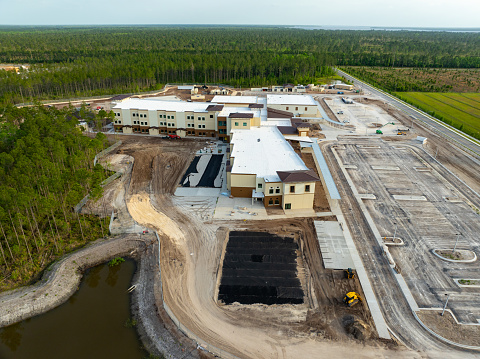K-8 School NN is being built to accept students from the Rivertown and Shearwater communities in northern St. Johns County, Florida. It will open in Fall of 2024. These are aerial shots of the school under construction in April 2024.