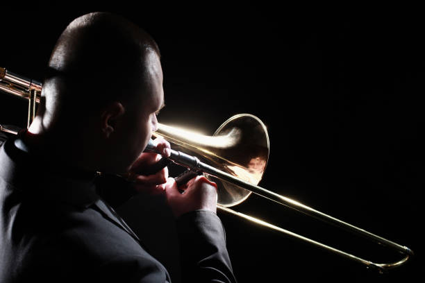 istock Trombone player. Trombonist playing brass instrument 2148295529