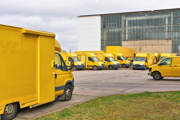 discarded dhl vehicles in the yard of a car recycler in magdeburg, germany - versand - fotografias e filmes do acervo