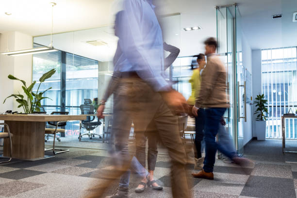 istock Businessman standing in the office. Other colleagues walking by. 2148295679