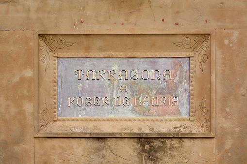 Tarragona, Spain - April 11, 2024: Plaque to Roger de Lauria, admiral of the Crown of Aragon, stands proudly in Tarragona, reflecting Catalan maritime
