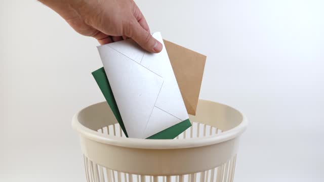 Paper envelopes are thrown into the trash. Paper recycling.