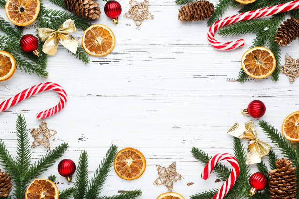 istock Fir tree branches with christmas ornaments on white wooden table 2148297029