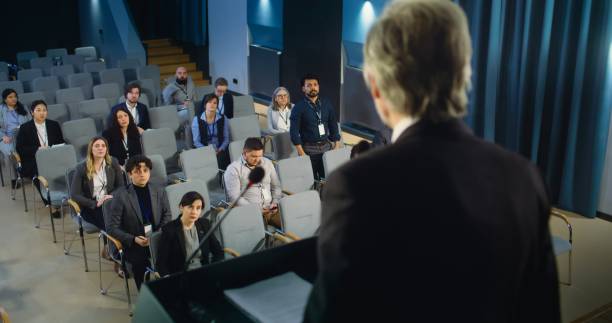 istock Back view of politician or activist pronouncing speech during press campaign 2148298043