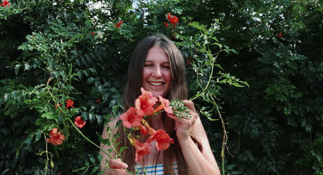 Portrait of Happy Woman With Tropical Flowering Plants