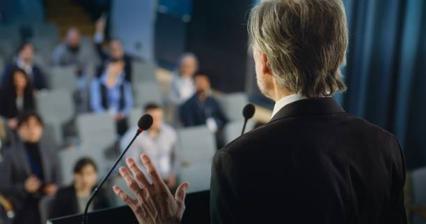 istock Back view of politician or activist pronouncing speech during press campaign 2148299669