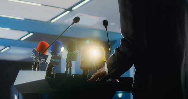 istock Male organization representative pronouncing speech from the tribune 2148300000