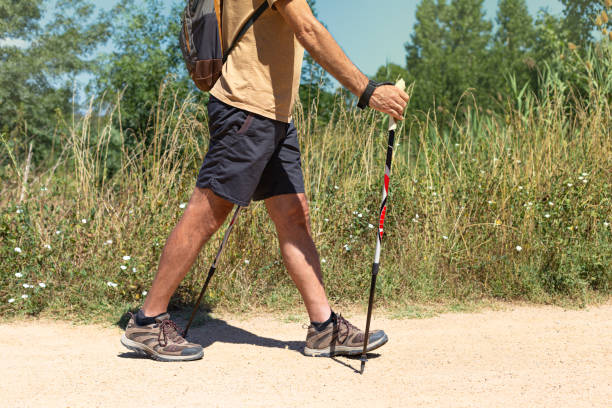istock Young man walking with trekking sticks. 2148300153
