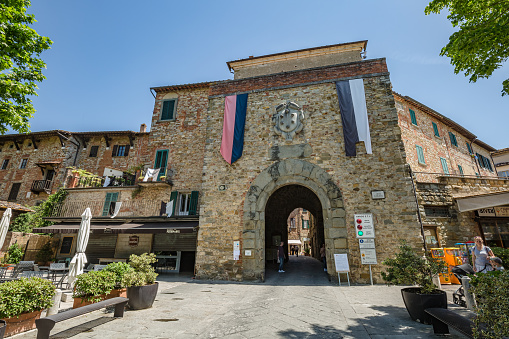 Lucignano , Italy - 23 of May 2022: Walking small historic town Lucignano. View of entrance gate of city center.