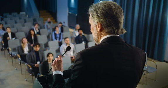 Shot of a mature businessman delivering a presentation at a conference