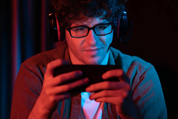 istock Smiling streamer team playing with Esport online on smartphone. Gusher. 2148301855