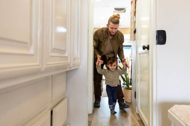 istock Young dad helps toddler daughter learn to walk 2148302215