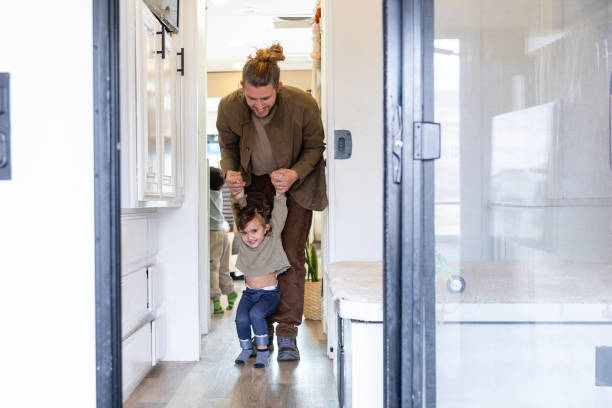 istock Dad helps playful daughter walk in motor home 2148302229