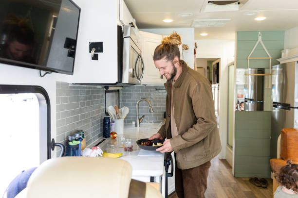 istock Cheerful father preps snack in motor home kitchen 2148302235