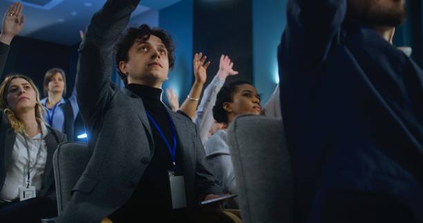 istock Multiethnic press workers raise hands sitting in the conference room 2148302279