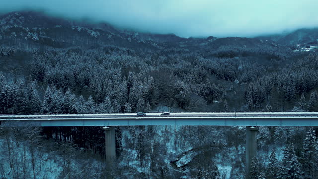 Car driving cross bridge in winter season