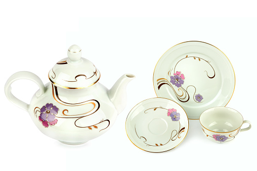Vintage porcelain teapot, cups and saucers isolated on white background. Collage.