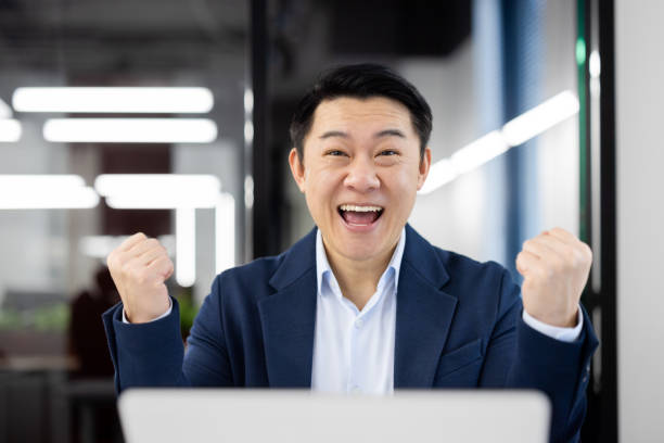 istock Joyful businessman celebrating success in the office 2148302471