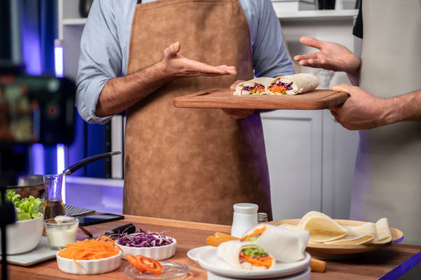 istock Cropped view of chef influencers presenting fresh salad roll. Sellable. 2148303081