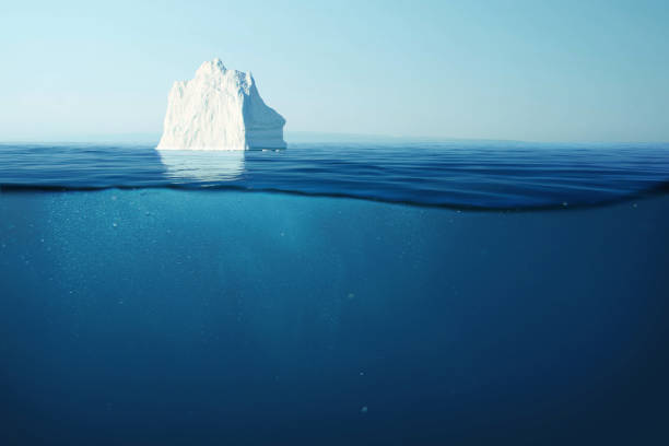 istock Iceberg floats in the ocean with an underwater view. Glacier melting and global warming concept 2148303498
