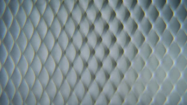 A dreamy macro shot of a metal grid, steel pattern, iron industrial texture, aluminum material, super slow motion, Full HD 120 fps, smooth crane zoom out movement, blurry Depth Of Field
