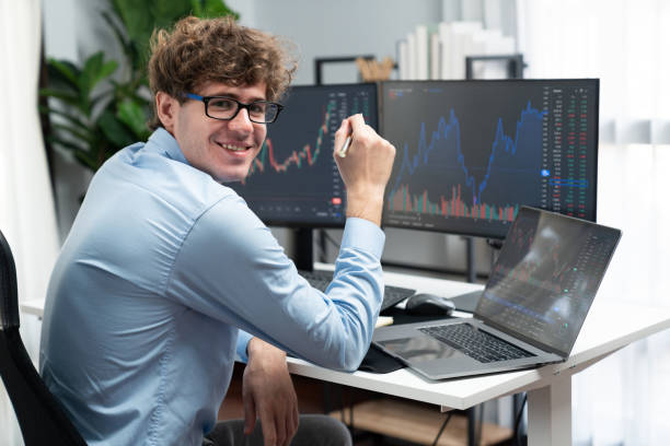 istock Profile of smiling stock trader sitting against on dynamic graph screen. Gusher. 2148303867
