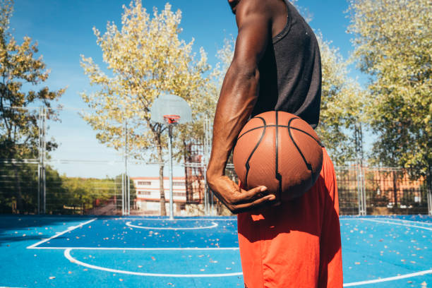 Unrecognizable afro man playing basketball