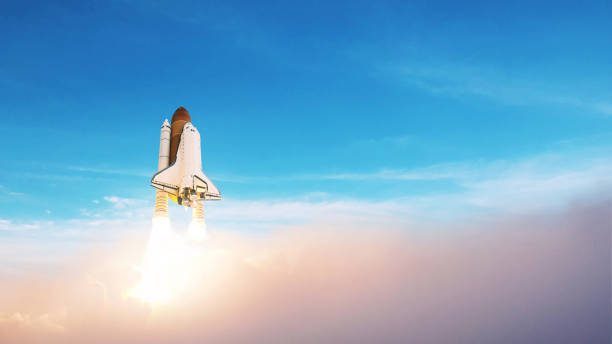istock Space rocket lift off into the blue sky. Launching a spaceship through the clouds 2148304705