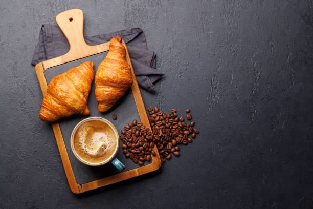 istock Cappuccino coffee and fresh croissants 2148305034