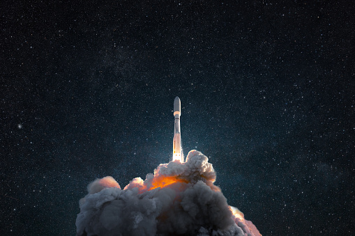 Successful launch of a rocket into space. Spaceship with smoke and blast lift off into the starry sky. Space wallpaper