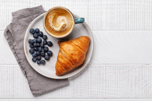 istock Cappuccino coffee and fresh croissant 2148305142