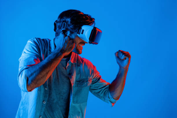 istock Side view of man wearing VR glass and smashing or punching at camera. Deviation. 2148305279