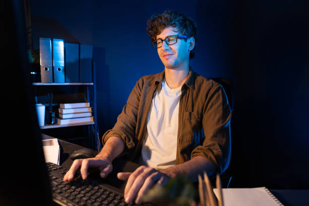 istock Businessman tying on pc on startup next planner at neon light office. Gusher. 2148305310
