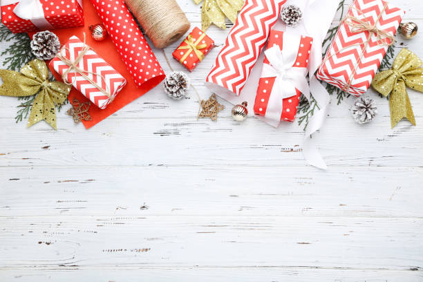 istock Gift boxes with ornaments on white wooden background 2148305630
