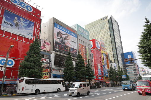 Chiyoda Ward, Japan - May 22, 2023: Traffic moves under the huge commercial signs in Akihabara Electric Town near Akihabara Station. Spring afternoon in the Tokyo Metropolis.