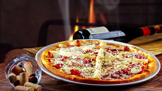Pizza baked in a wood-fired oven and red wine