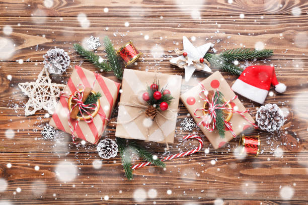 istock Gift boxes with ornaments on brown wooden background 2148307139