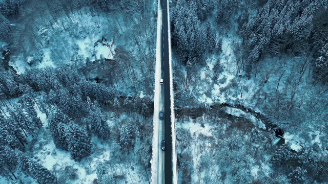Aerial view car driving cross bridge in winter season