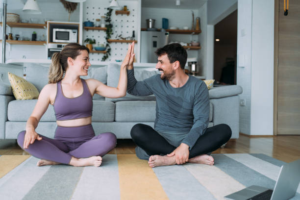 istock Couple giving each other high five after a successful workout at home. 2148308306