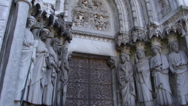 Sculptures of the Holy Apostles near the main entrance to the Cathedral of St. Finbarr in the Irish city of Cork. Statues adorn the facade of the Anglican church. European religious art. Video.