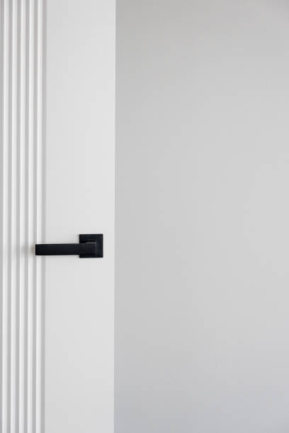 istock Modern black door handle on white wooden door in interior. 2148308671