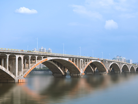 In the heart of Huizhou City, the majestic Dongjiang Bridge spans the crystal-clear waters of the Dongjiang River, offering a breathtaking sight that seamlessly blends natural beauty with modern infrastructure.