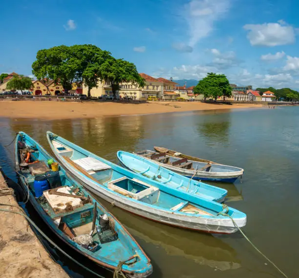 Photo of Small traditional fishing boats lining a dock in SÃ£o TomÃ©, SÃ£o TomÃ© and Principe (STP), Central Africa