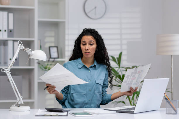 istock Confused Hispanic businesswoman working from home office 2148312073