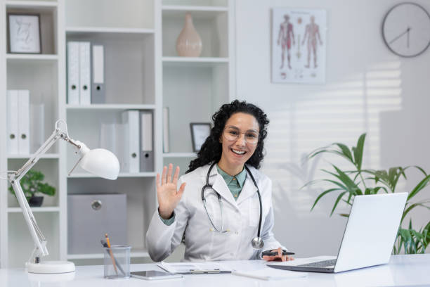 istock Friendly Hispanic doctor greeting in a bright office 2148312146