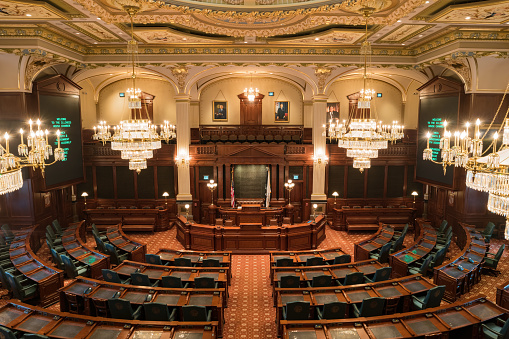The Illinois House of Representatives Chamber in the Illinois State Capitol building in Springfield, Illinois, USA on a cloudy spring day. This is where representatives of the lower house of the Illinois General Assembly meet to pass bills.
