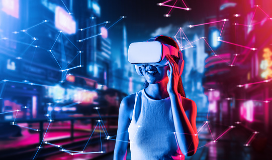Female standing in cyberpunk style building in meta wear VR headset connecting metaverse, future cyberspace community technology, Woman using hand holding goggles while looking faraway. Hallucination.