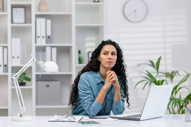 istock Hispanic businesswoman thinking in home office setting 2148312514