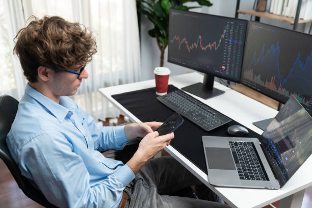 istock Young investor looking on smartphone surrounded current market screen. Gusher. 2148313138